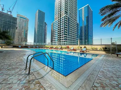a swimming pool in a city with tall buildings at Higuest - Lake-view Studio in JLT in Dubai