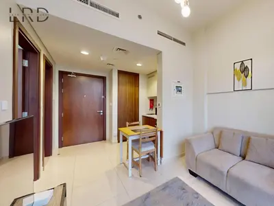 a living room with a couch and a table at Elegant 1BR with Stunning Canal Views in Dubai