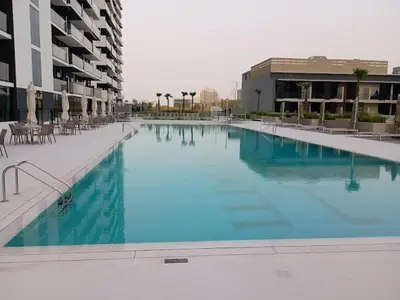 a large pool of blue water in a building at Stunning 1 Bdr luxury residence at JVC in Dubai