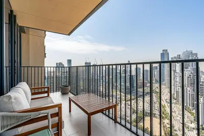 a balcony with a view of a city skyline at Stylish 1BR with Pool, Gym, BBQ Area & Playground in Dubai
