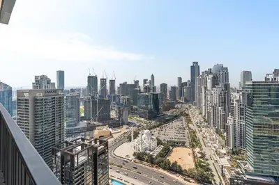 an aerial view of a city with traffic at Stylish 1BR with Pool, Gym, BBQ Area & Playground in Dubai