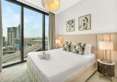 a bedroom with a large bed and a large window at Address Residences Stay in Dubai