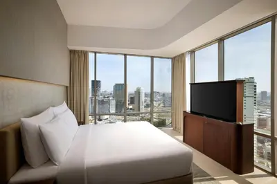 a hotel room with a bed and a flat screen tv at Hotel Local Dubai, Jumeirah Village Triangle, Autograph Collection in Dubai