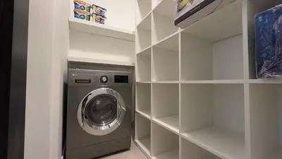 a washer and dryer in a walk in closet at Elite Business & Family Turnkey 433 Residence 2BR in OIA Motor City in Dubai