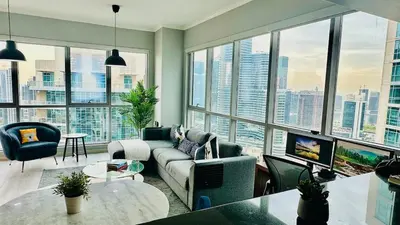 a living room with a lot of windows at Dubai I Burj Residence Retreat I Piano & Workstation in Dubai