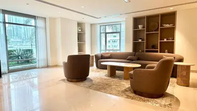 a living room with a couch and a table and chairs at Dubai I Burj Residence Retreat I Piano & Workstation in Dubai