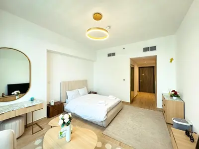 a hotel room with a bed and a mirror at Modern Studio Living in JVC's Regina Tower in Dubai