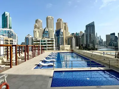 a swimming pool on a balcony with a city skyline at Cozy Studio at DEC Tower in Dubai