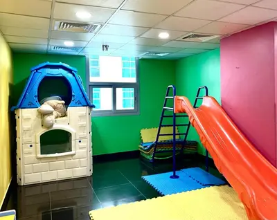 a play room with a slide and a play house at Cozy Studio at DEC Tower in Dubai
