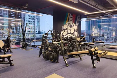 a gym with lots of exercise equipment and a picture of a man at MBL Royal Luxury 1BR on High Floor in Dubai