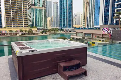 a hot tub on a balcony with a city skyline at MBL Royal Luxury 1BR on High Floor in Dubai
