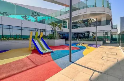 a playground with a slide in front of a building at Luxury 1 Bed in the heart of the city! Free WiFi in Dubai