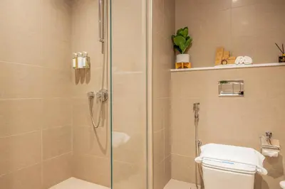 a bathroom with a glass shower with a toilet at 2BR Boutique Apartments at Burj Royale - Burj Khalifa & Dubai Mall in Dubai