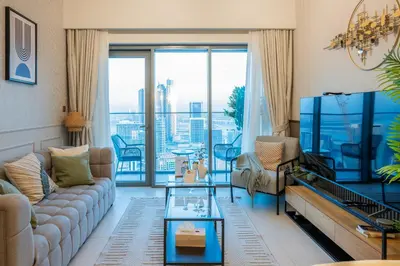 a living room with a couch and a large window at 2BR Boutique Apartments at Burj Royale - Burj Khalifa & Dubai Mall in Dubai