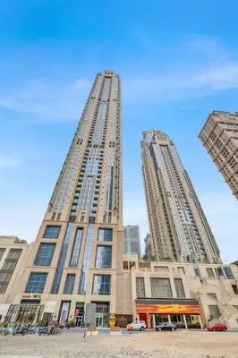 two tall buildings in front of a blue sky at luxury apartment at Al Habtoor city in Dubai