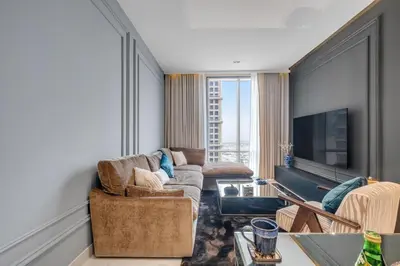 a living room with a couch and a tv at luxury apartment at Al Habtoor city in Dubai