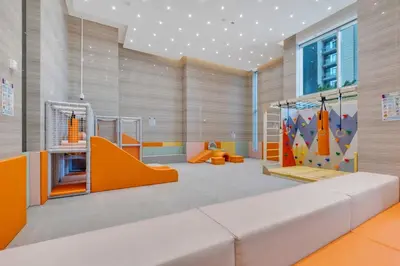 a childrens play room with a rock wall at luxury apartment at Al Habtoor city in Dubai