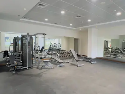 a gym with a lot of treadmills and machines at D Stays holiday homes 1min walk to Dubai mall & Burj Khalifa in Dubai