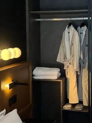 a room with a closet with a robe and towels at D Stays holiday homes 1min walk to Dubai mall & Burj Khalifa in Dubai