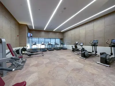 a gym with rows of exercise bikes and treadmills at High-Rise Studio Overlooking the Sea with a Glimpse of Ain Dubai, The Palm Tower, Palm Jumeirah by Deluxe Holiday Homes in Dubai