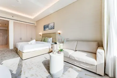 a hotel room with a bed and a couch at High-Rise Studio Overlooking the Sea with a Glimpse of Ain Dubai, The Palm Tower, Palm Jumeirah by Deluxe Holiday Homes in Dubai