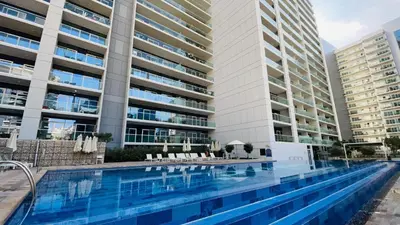 a swimming pool in front of two tall buildings at AWS Holiday Homes - Top Retreat near the Burj in Dubai