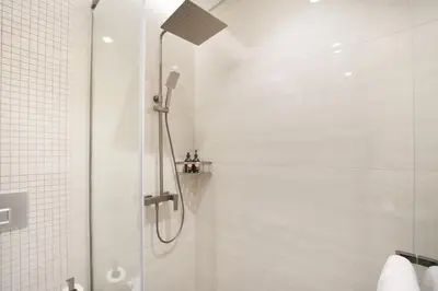 a shower with a shower head in a bathroom at EasyGo- Luxury 1BR with Burj Khalifa view and lavish Amenities in Dubai