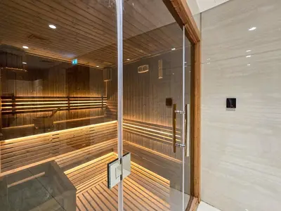 a sauna with a glass door in a building at EasyGo- Luxury 1BR with Burj Khalifa view and lavish Amenities in Dubai