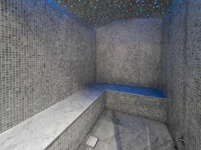a shower in a room with a tile wall at EasyGo- Luxury 1BR with Burj Khalifa view and lavish Amenities in Dubai