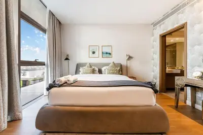 a bedroom with a large bed with a large window at FAM Living -Duplex 4Bed and Maids in Dubai