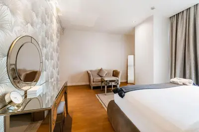 a bedroom with a bed and a mirror and a chair at FAM Living -Duplex 4Bed and Maids in Dubai