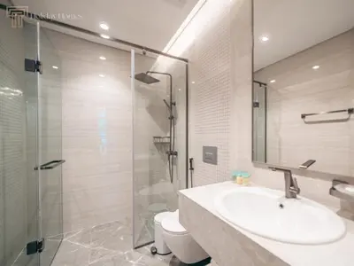 a bathroom with a sink and a glass shower at Modern 1-Bed Apartment in a Prime Central Location in Dubai