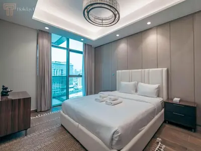 a bedroom with a large bed and a large window at Modern 1-Bed Apartment in a Prime Central Location in Dubai