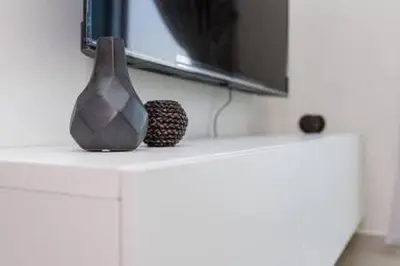 a vase sitting on top of a white cabinet at Contemporary 2 Bedroom Apartment in Dubai