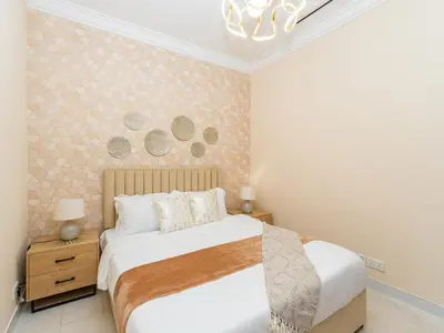 a bedroom with a bed and a chandelier at Exclusive 2BR in Al Yass Tower Dubai Marina - Private Terrace & Premium Community, Managed by Think Realty in Dubai