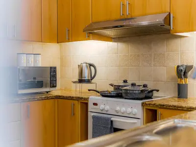 a kitchen with a stove and a microwave at Exclusive 2BR in Al Yass Tower Dubai Marina - Private Terrace & Premium Community, Managed by Think Realty in Dubai