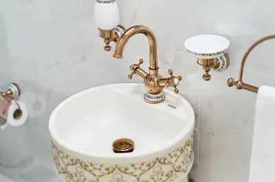 a bathroom sink with a gold faucet at High Floor Upgraded 2BR in JLT - Walk to Lake Park in Dubai