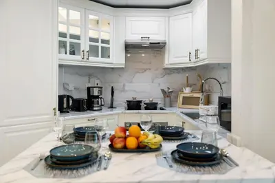 a kitchen with a table with fruits and plates on it at High Floor Upgraded 2BR in JLT - Walk to Lake Park in Dubai