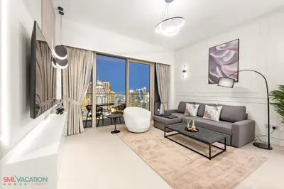 a living room with a couch and a table at SML Vacation Homes - Sky High Apartments with Burj Khalifa and Dubai Fountain Views at Grande Signature, Downtown Dubai in Dubai