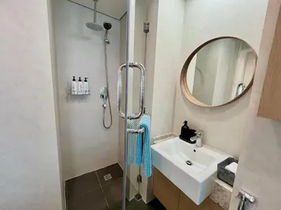 a bathroom with a shower and a sink and a mirror at Upgraded & Cozy Boutique Studio in Palm Jumeirah PV7 in Dubai