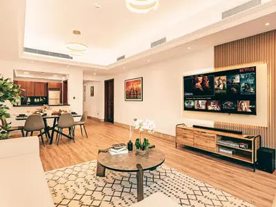 a living room with a large flat screen tv at New Fairmont Residence Private Beach club access Palm Jumeirah in Dubai
