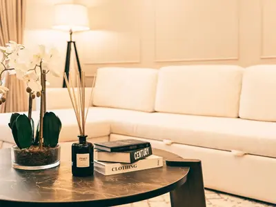 a living room with a couch and a table with books at New Fairmont Residence Private Beach club access Palm Jumeirah in Dubai