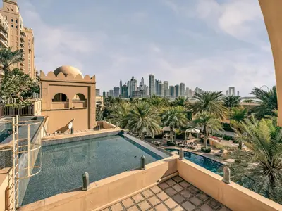 a view from the balcony of a hotel with a swimming pool at New Fairmont Residence Private Beach club access Palm Jumeirah in Dubai
