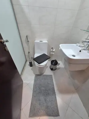a bathroom with a toilet and a sink at Studio in Hera towers, Dubai sports city in Dubai