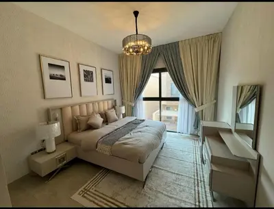 a bedroom with a bed and a chandelier at 1 bedroom apartment in Jumeirah in Dubai