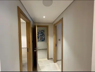 a hallway with two doors to a room with a hallway at 1 bedroom apartment in Jumeirah in Dubai