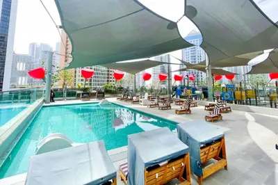 a pool on the roof of a building at Top Floor Studio with Sofa Bed Walk to Dubai Mall by Vibel in Dubai