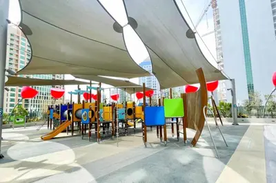 a group of tables and chairs under an umbrella at Top Floor Studio with Sofa Bed Walk to Dubai Mall by Vibel in Dubai