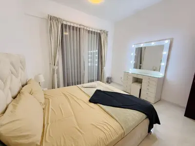 a bedroom with a bed with a mirror and a dresser at 1BHK LUXURY PRIVATE APARTMENT - Dubai Marina - 2 MIN WALK FROM TRAM in Dubai
