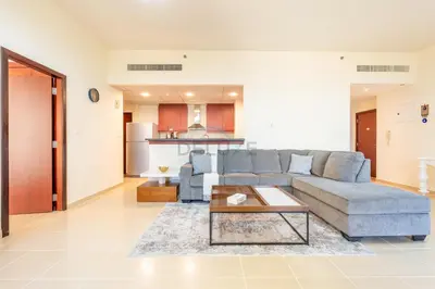 a living room with a couch and a table at Sea-Facing 1BR with Ain Dubai View Close to Marina Beach, Rimal 3, Jumeirah Beach Residence by Deluxe Holiday Homes in Dubai